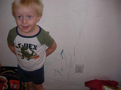 Quinan posing with a drawing on the wall.